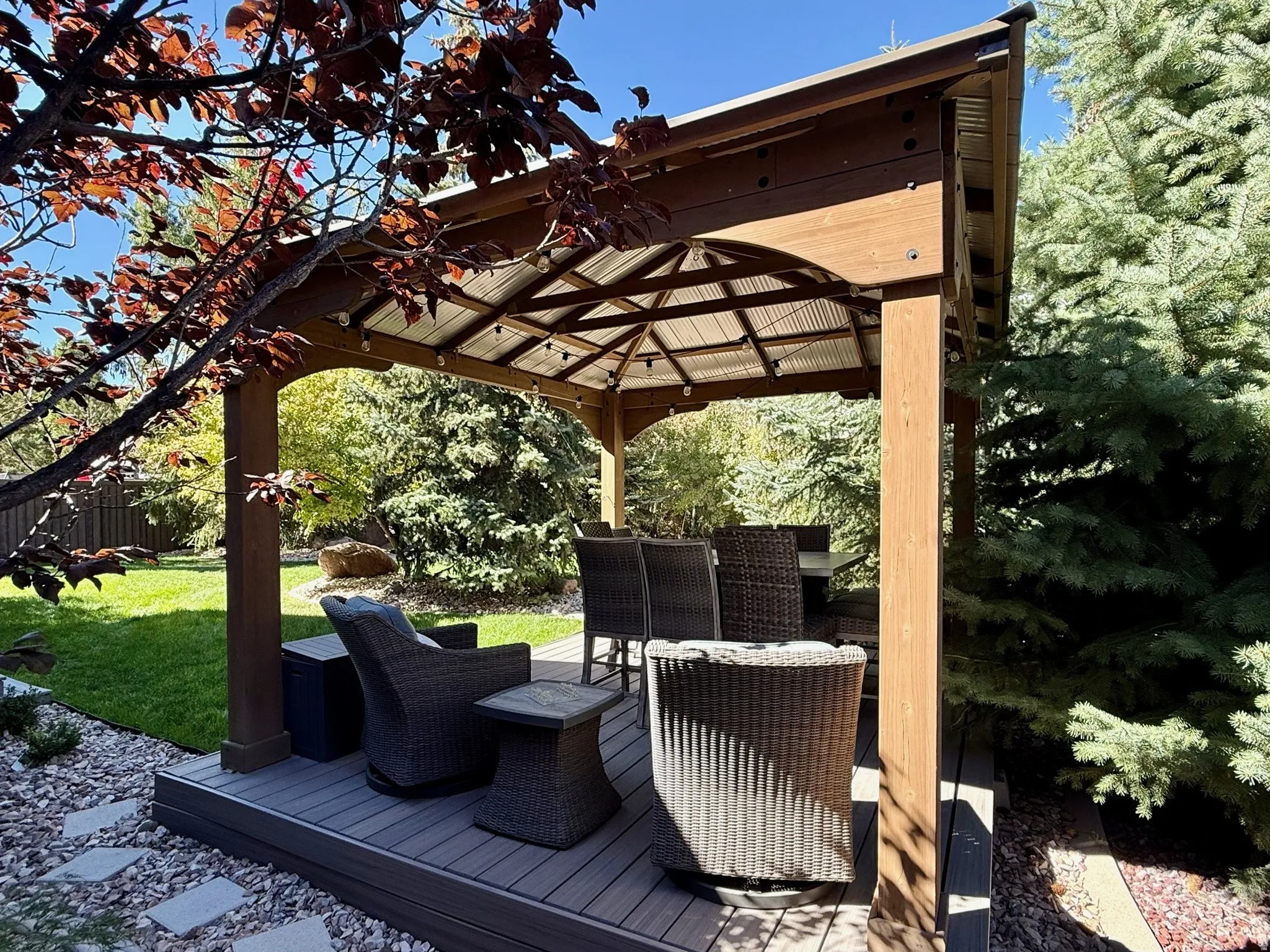 Outdoor gazebo with a composite deck base and wood-finish framing