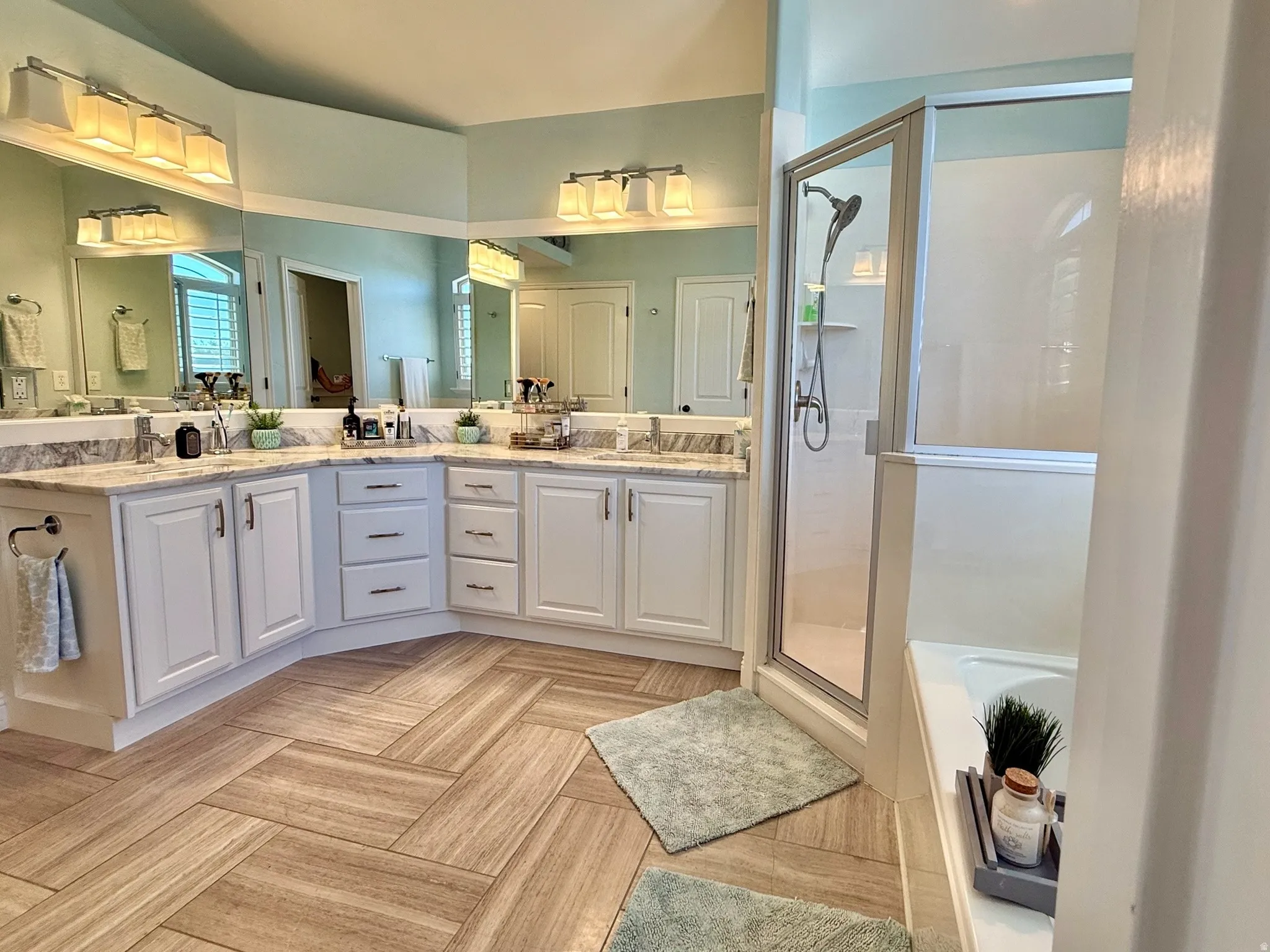 Master Bathroom-Dual vanity with white cabinetry and light-toned countertops