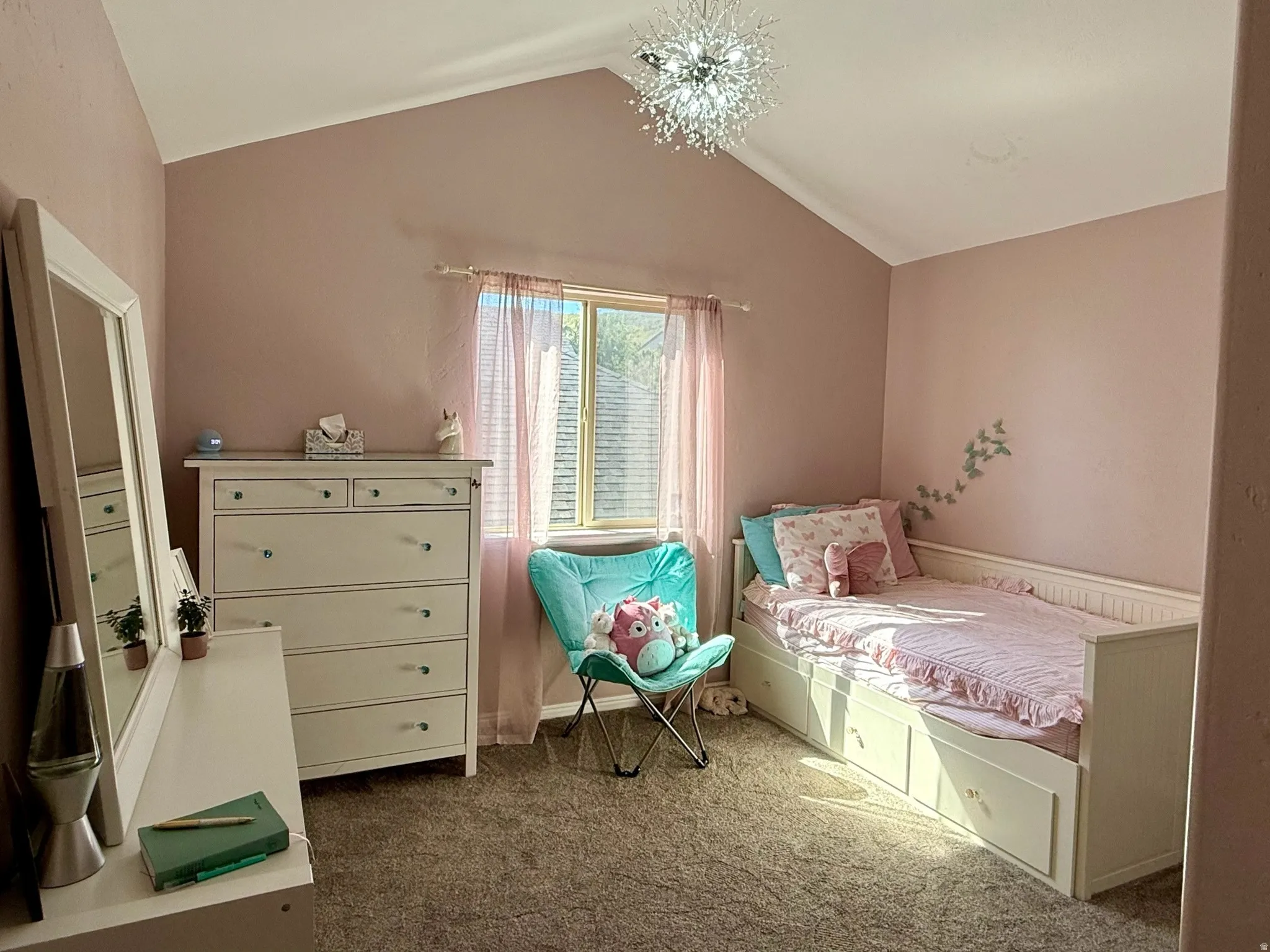 Room featuring vaulted ceiling with a modern light fixture, window with blinds, and carpeted flooring