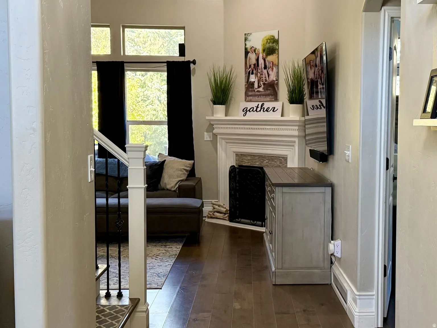Expansive entry hall featuring wood-finish flooring, a vaulted ceiling, and an arched doorway