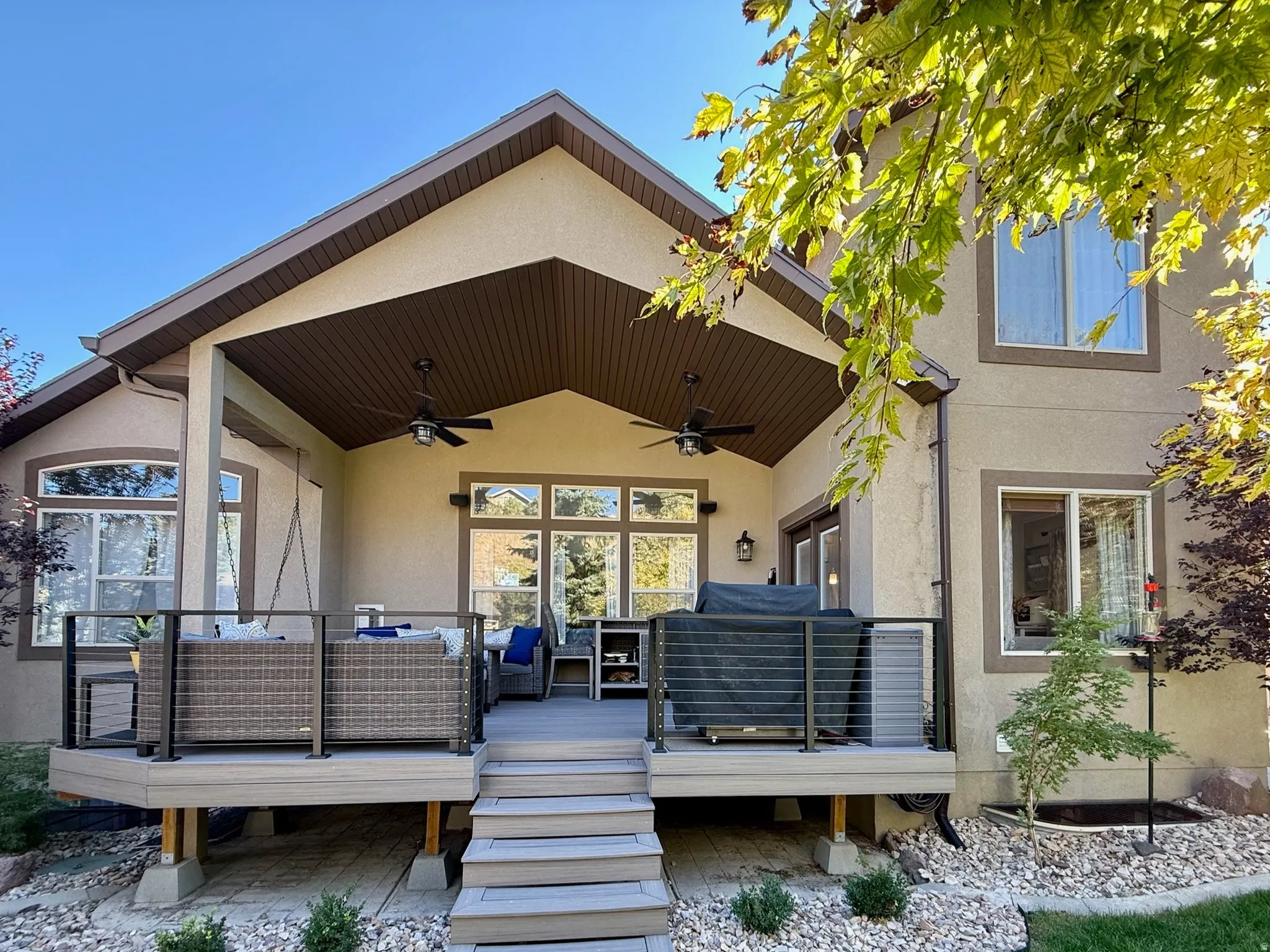 Spacious outdoor deck with railing system and integrated steps
