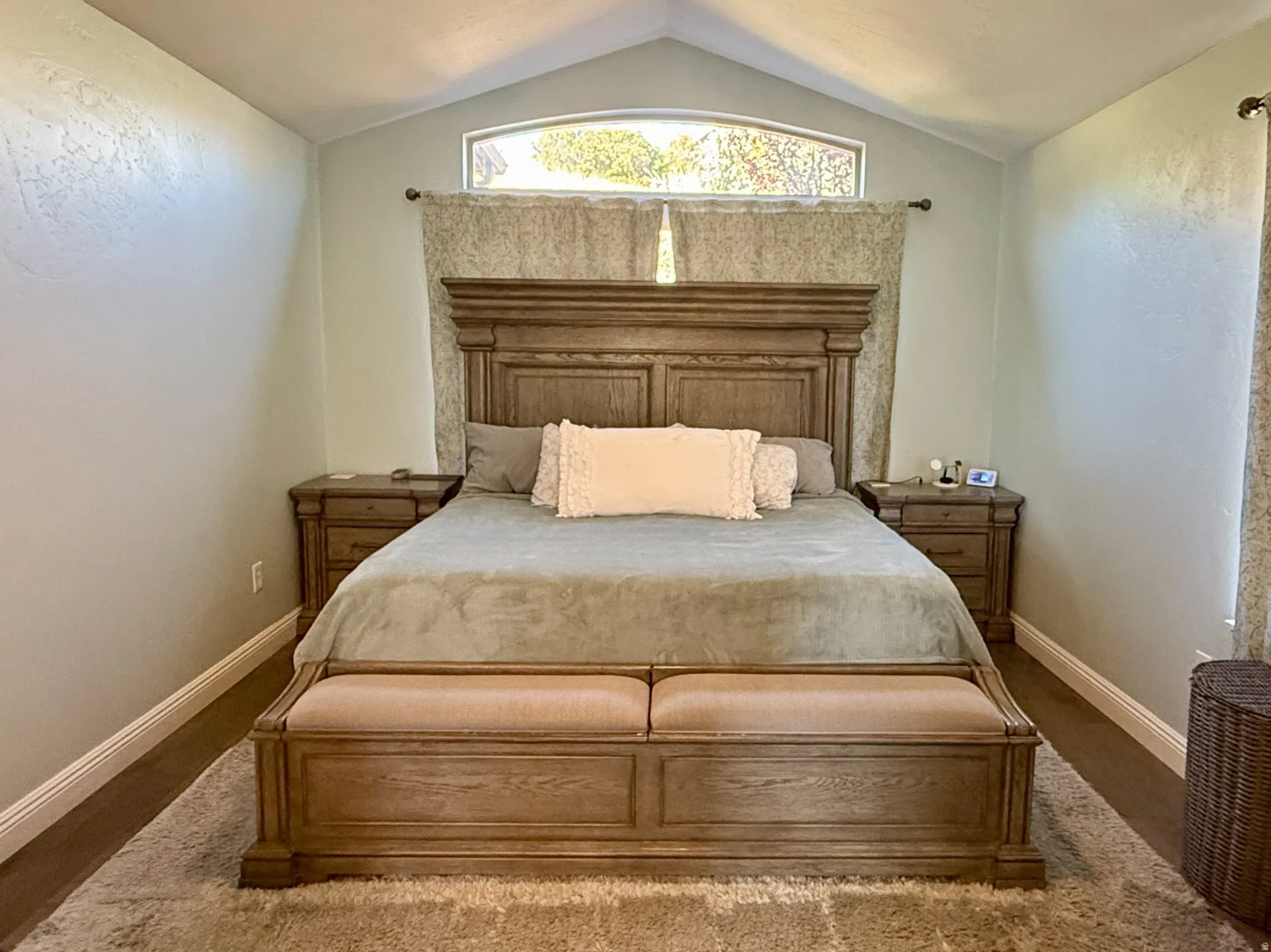 Master Bedroom- Vaulted ceiling with an arched window above the bed