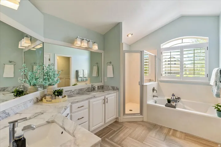 Primary Bathroom- Dual vanity with integrated sinks and stone-finish countertops