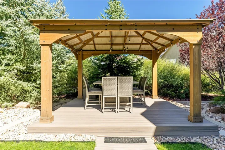 Wood gazebo with a metal roof, composite decking, and integrated lighting
