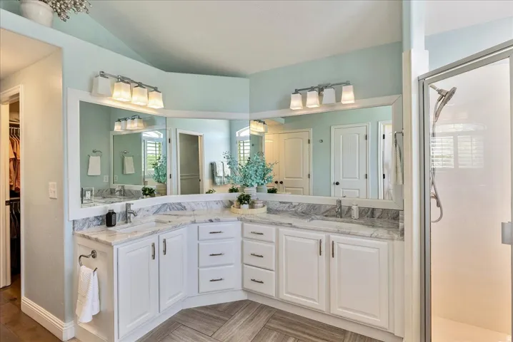 Primary Bathroom- Dual vanity with white cabinetry and integrated sinks