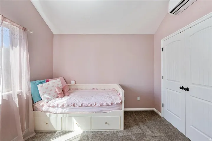 Plaster walls, white trim, carpet flooring, and a built-in closet with white paneled doors