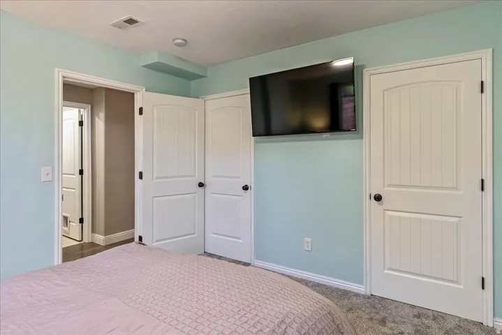 White paneled interior doors, wall-to-wall carpeting, and light blue wall finish