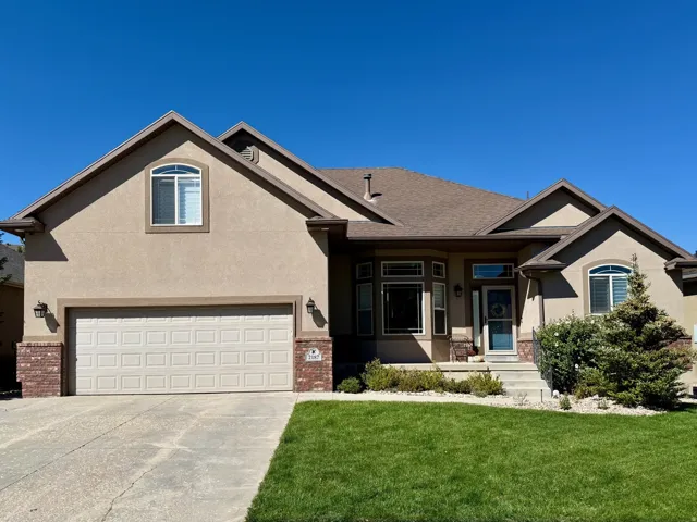 Stucco exterior with brick accents and a gabled roofline