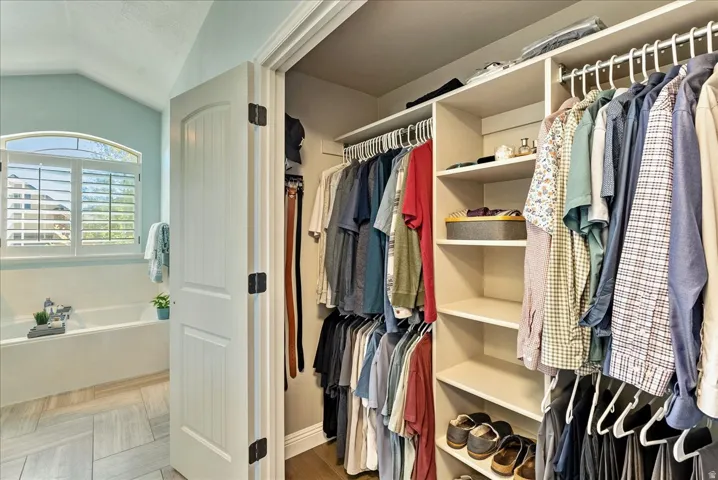 Second Primary Suite Closet- Walk-in closet with built-in shelving and hanging rods