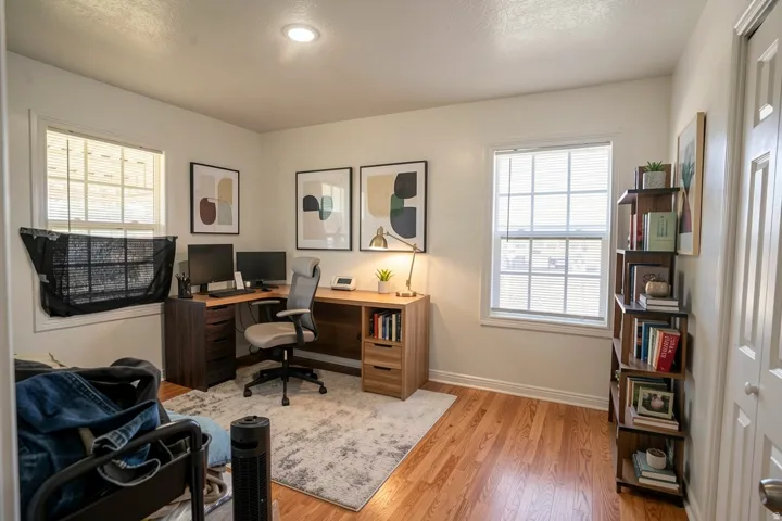 Hardwood-finish flooring, recessed lighting, and dual windows with blinds