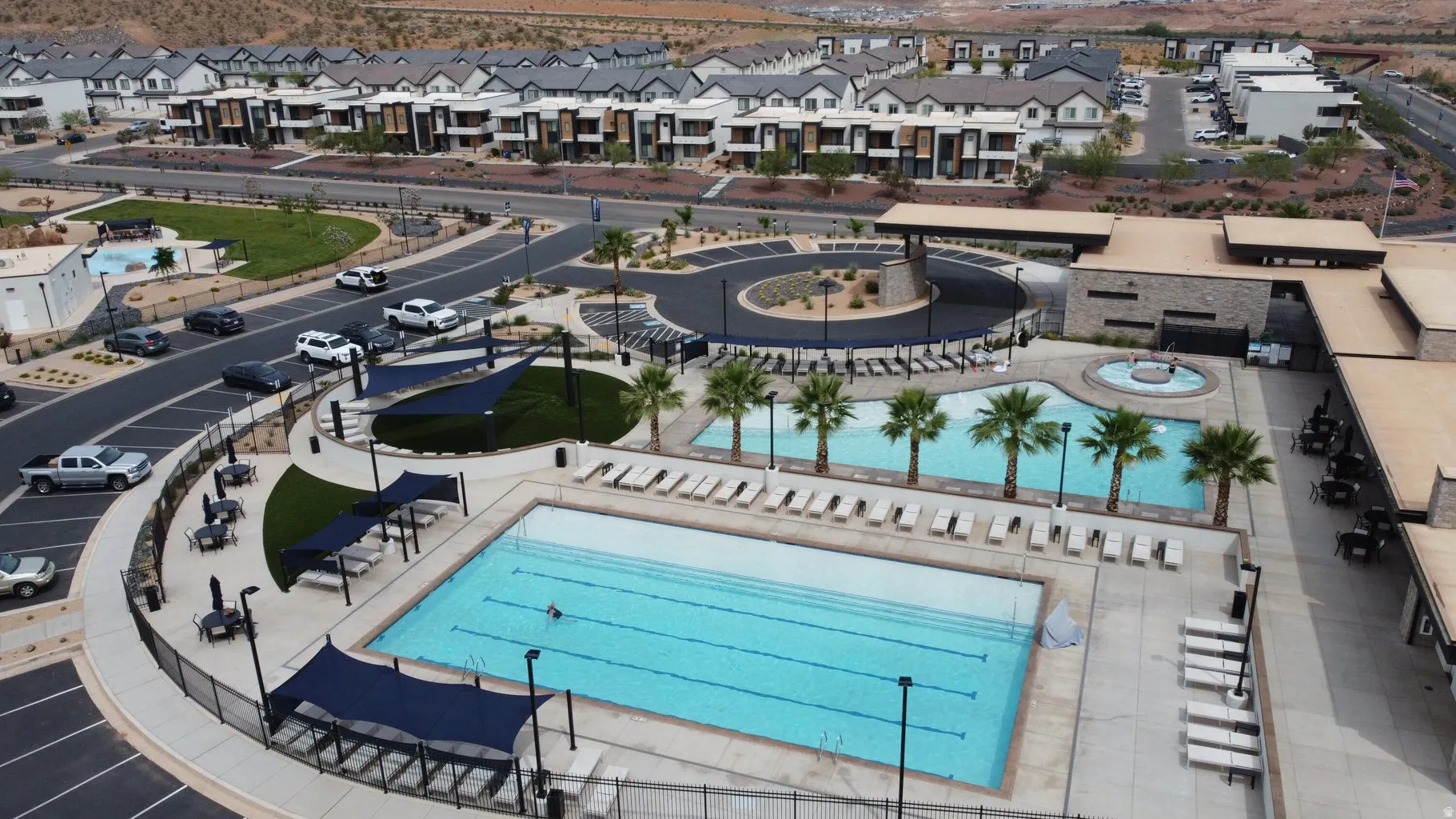 Community recreation area featuring a lap pool, secondary pool, and an integrated spa