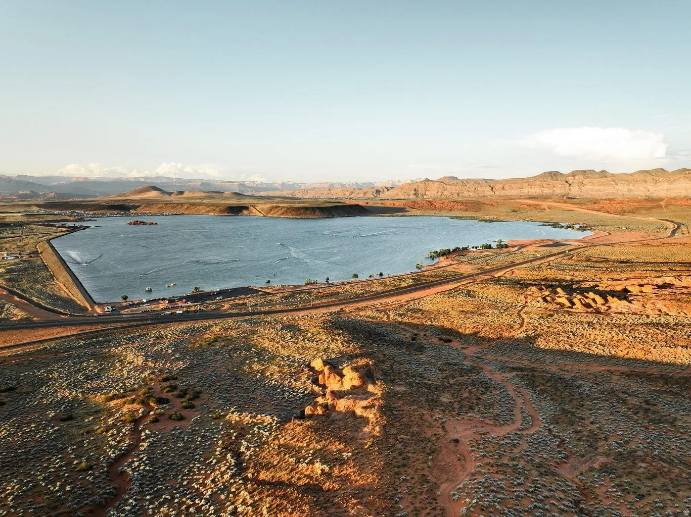 Expansive lake with surrounding desert landscape and distant mountains