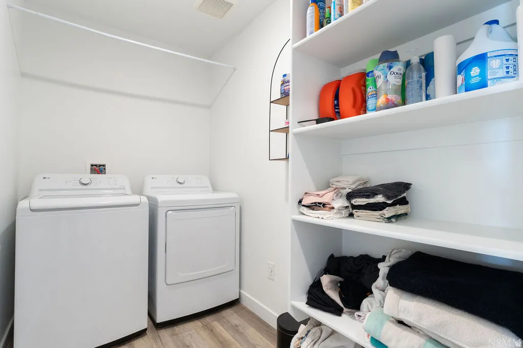 Dedicated laundry area featuring a full-size washer and dryer