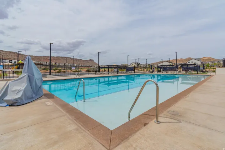 Rectangular swimming pool with light blue water and a concrete deck