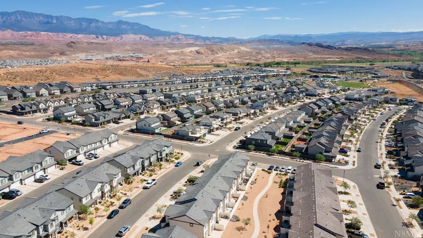 Expansive residential community featuring a variety of single-family homes and townhomes with gray roofing