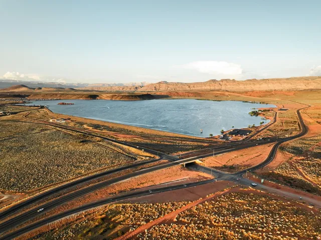 Expansive land parcel featuring direct road access, a bridge overpass, and proximity to a large body of water