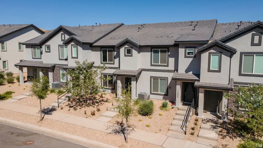 Modern townhome facade featuring stucco and stone accents
