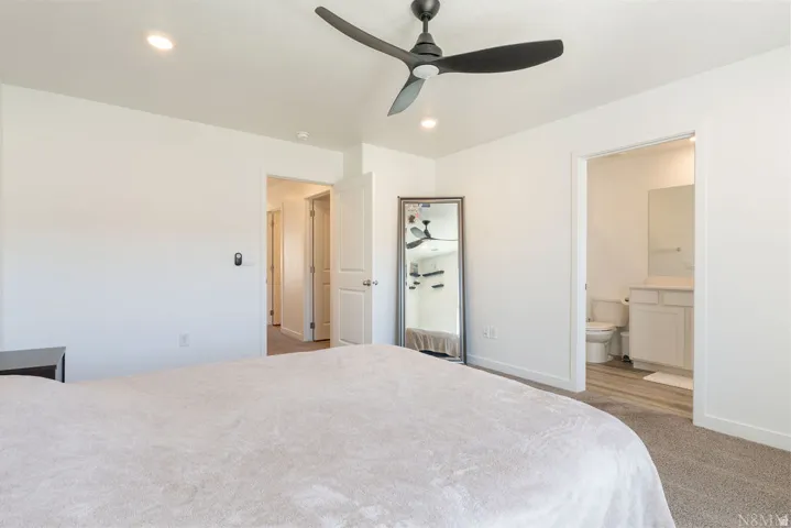 Spacious room featuring vaulted ceilings, recessed lighting, and a modern ceiling fan
