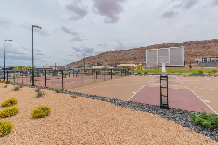 Outdoor sports courts featuring a basketball court and multiple tennis courts