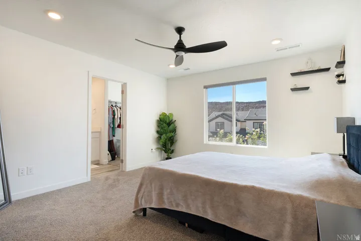 Bedroom featuring a large window, recessed lighting, and a ceiling fan