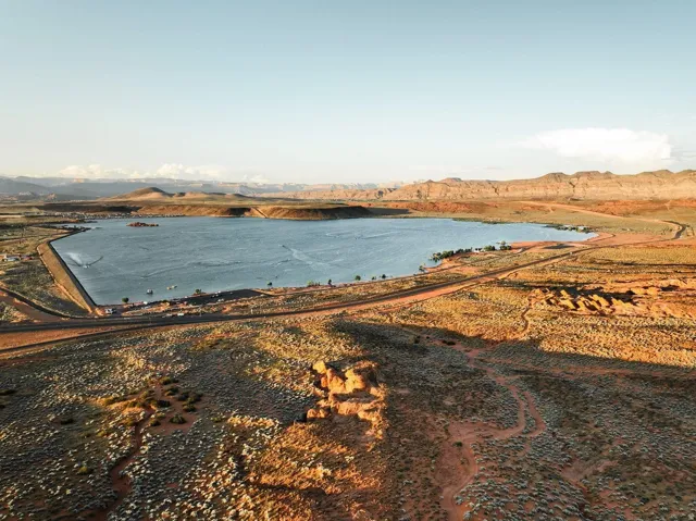 Expansive lake with surrounding desert landscape and distant mountains