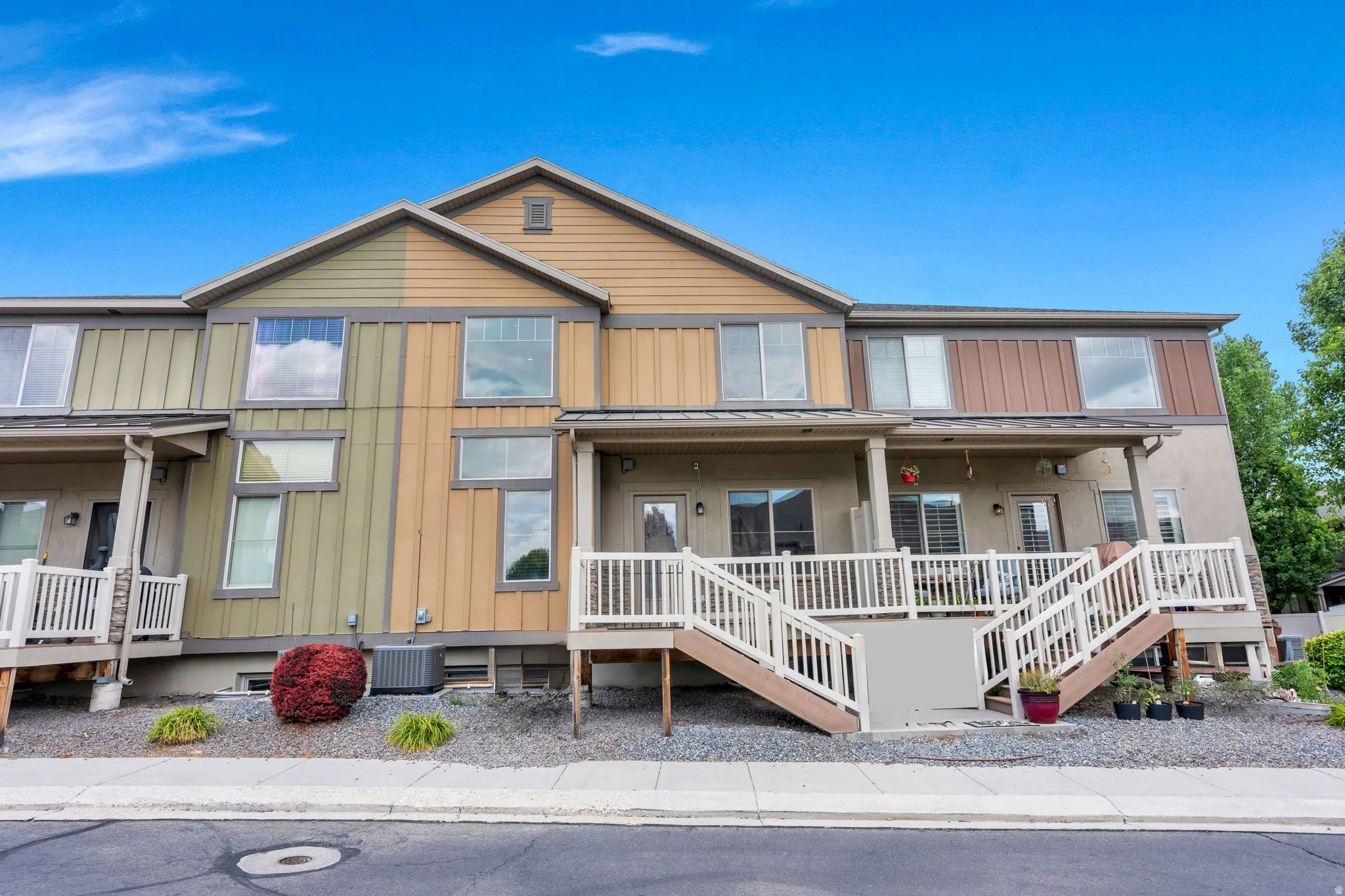 Multi-level townhome exterior with varied siding textures and colors