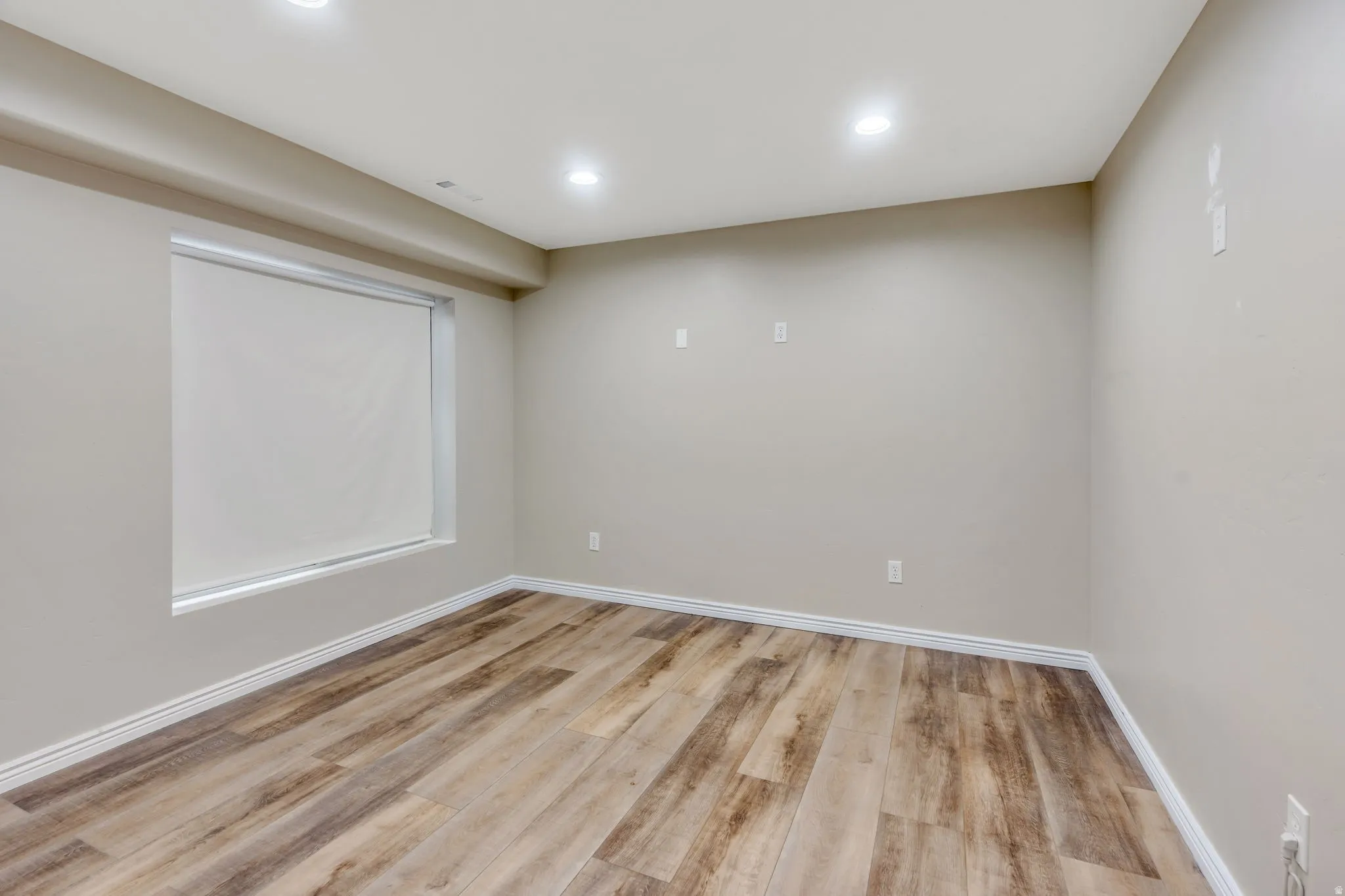 Recessed lighting illuminates neutral-toned walls