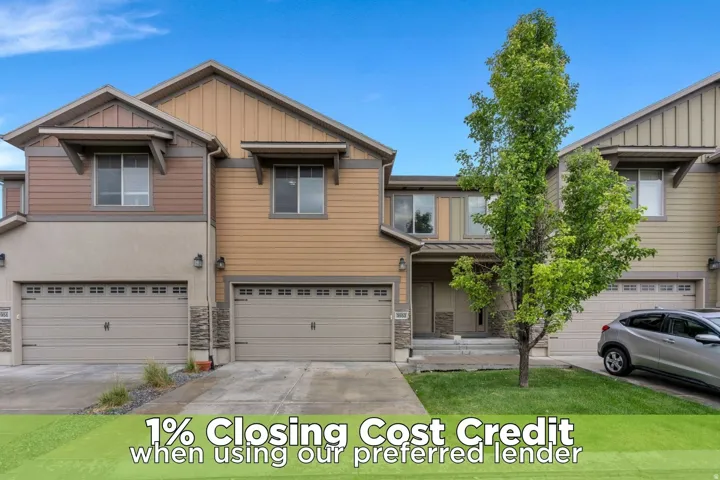Contemporary multi-level townhome featuring a neutral color palette, attached two-car garage, and a covered porch entry
