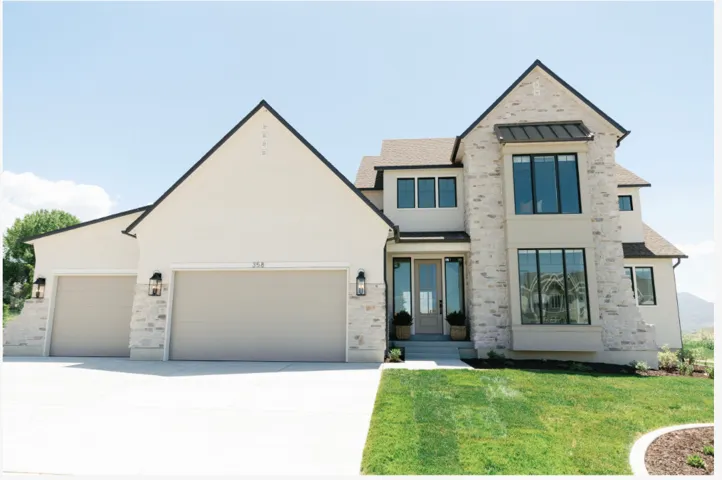 Modern exterior featuring light-toned stone and stucco finishes