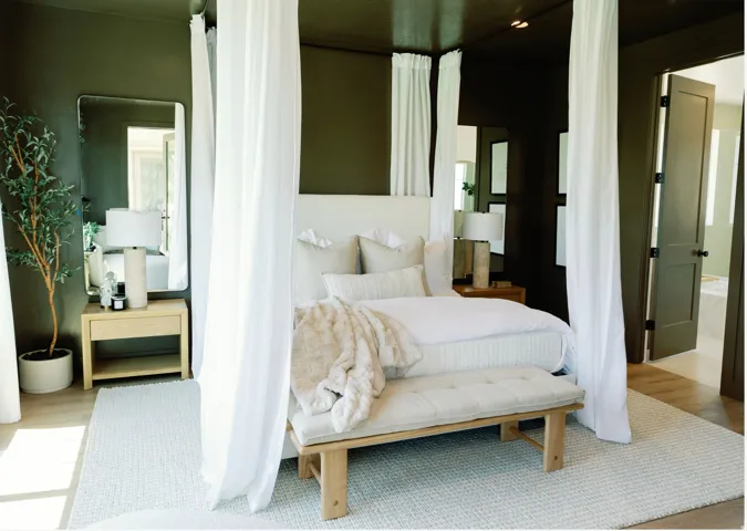 Bedroom featuring dark olive walls and ceiling, wood-finish flooring, a contemporary mirror, and a solid core door