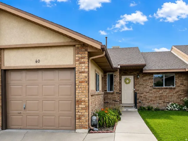 Brick exterior with a single-car garage and concrete driveway
