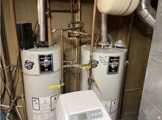 Dual water heaters featuring copper and galvanized piping, dedicated ball valves, and a water treatment system