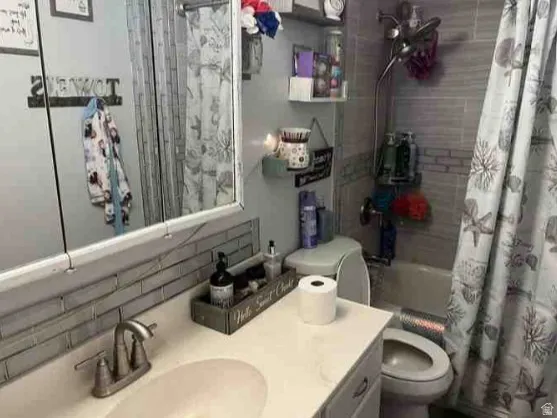 Bathroom featuring a built-in vanity with an integrated sink and a two-handle faucet