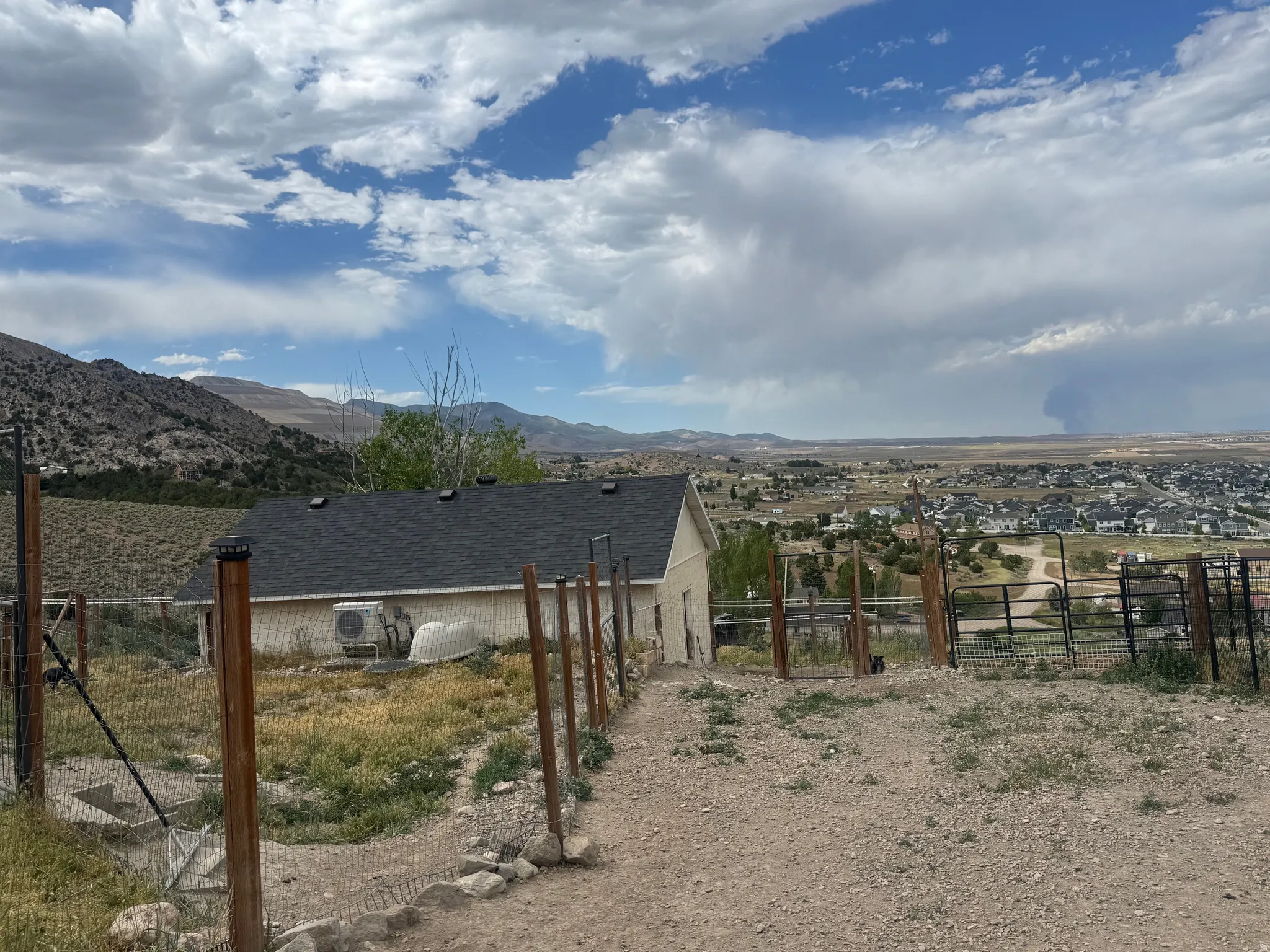 Elevated property featuring a gravel path and wire fencing