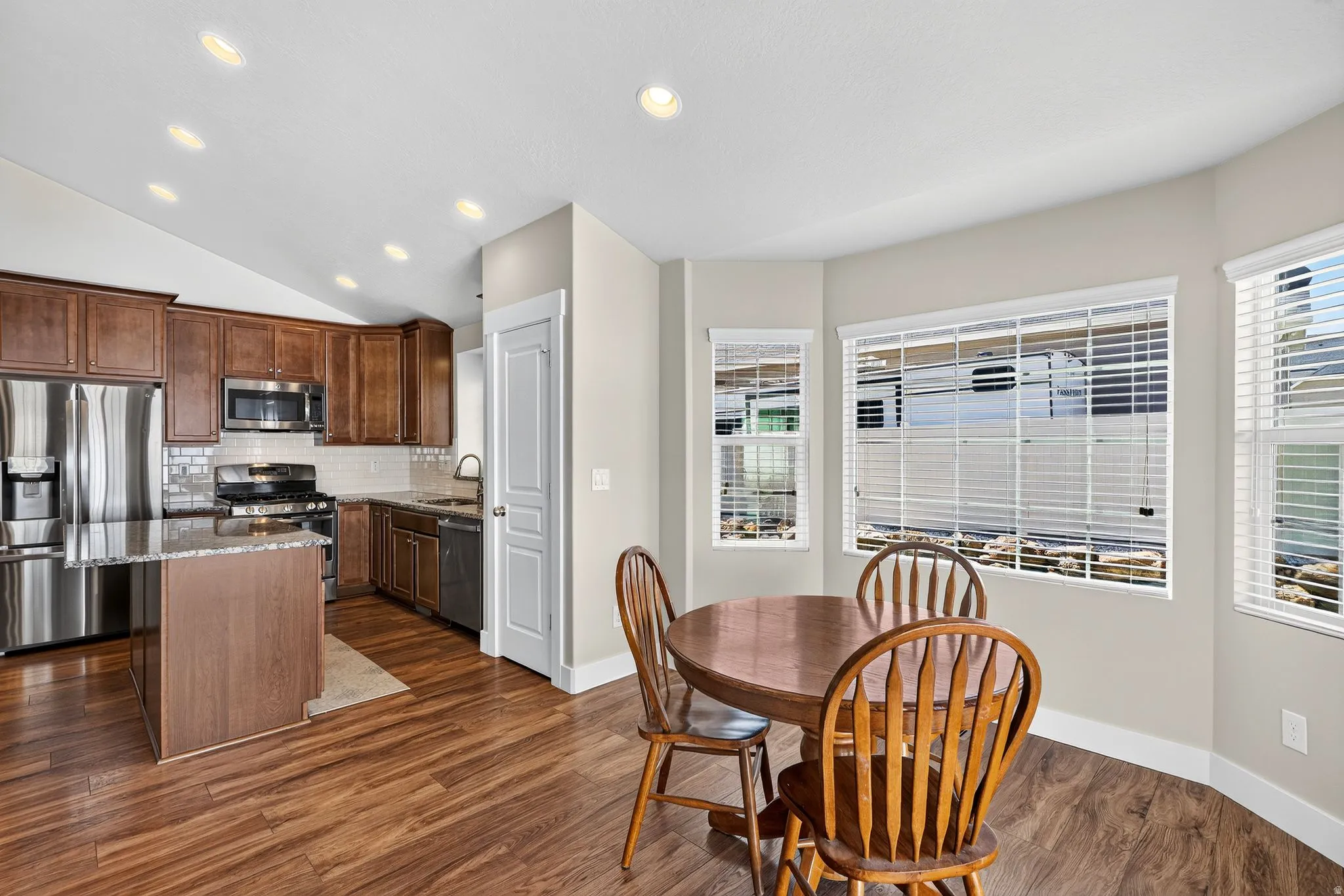 Kitchen and dining area featuring wood-finish flooring