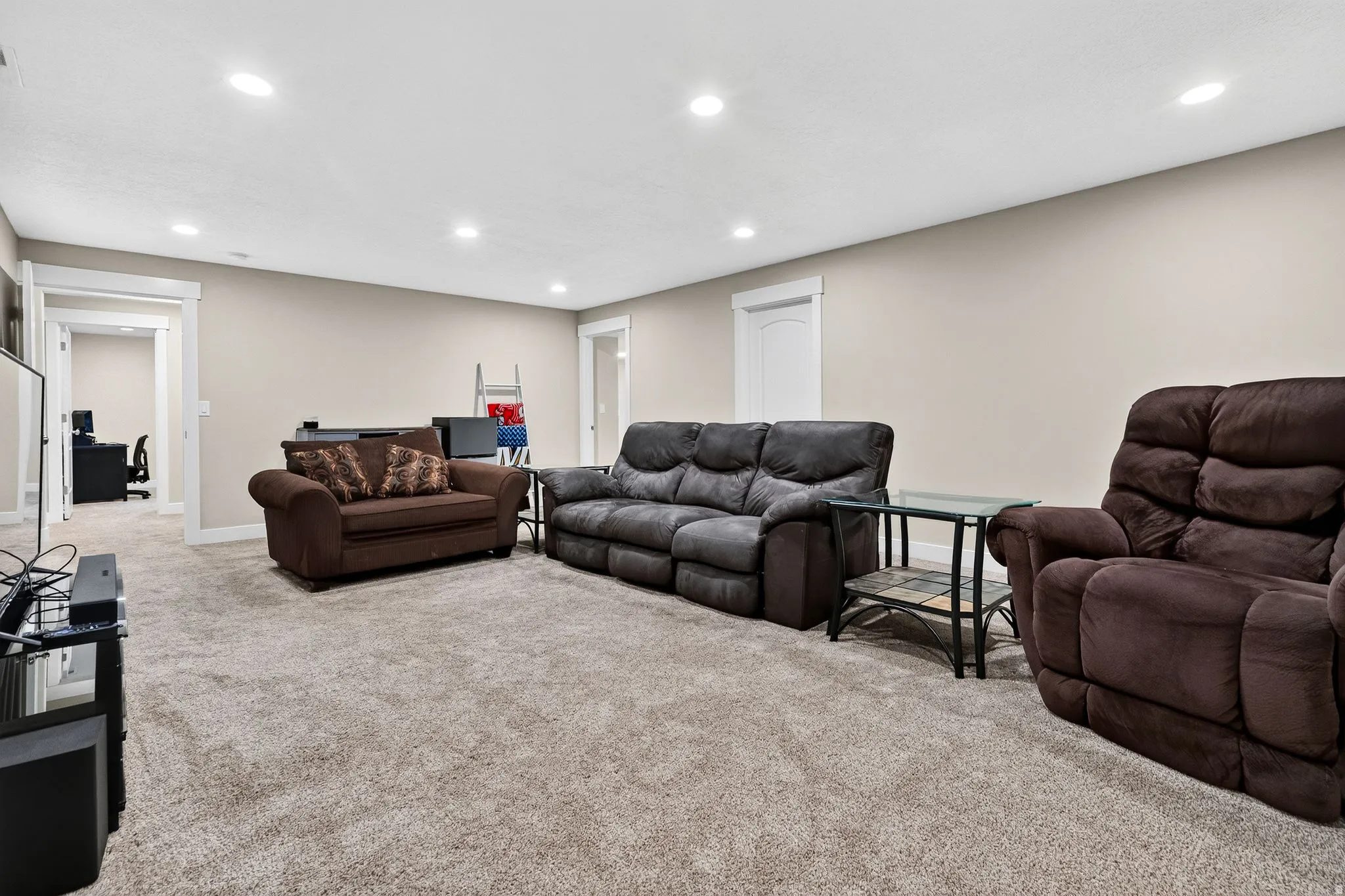 Spacious carpeted room featuring recessed lighting and neutral wall paint