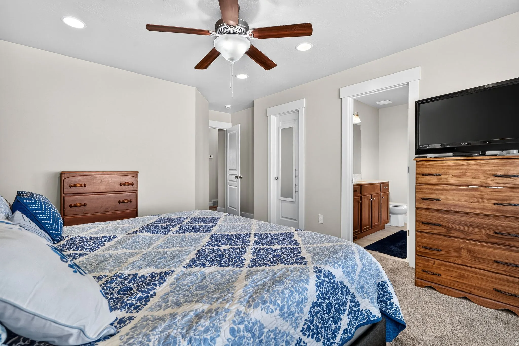 Carpeted bedroom featuring recessed lighting, a ceiling fan with integrated light, and crisp white trim
