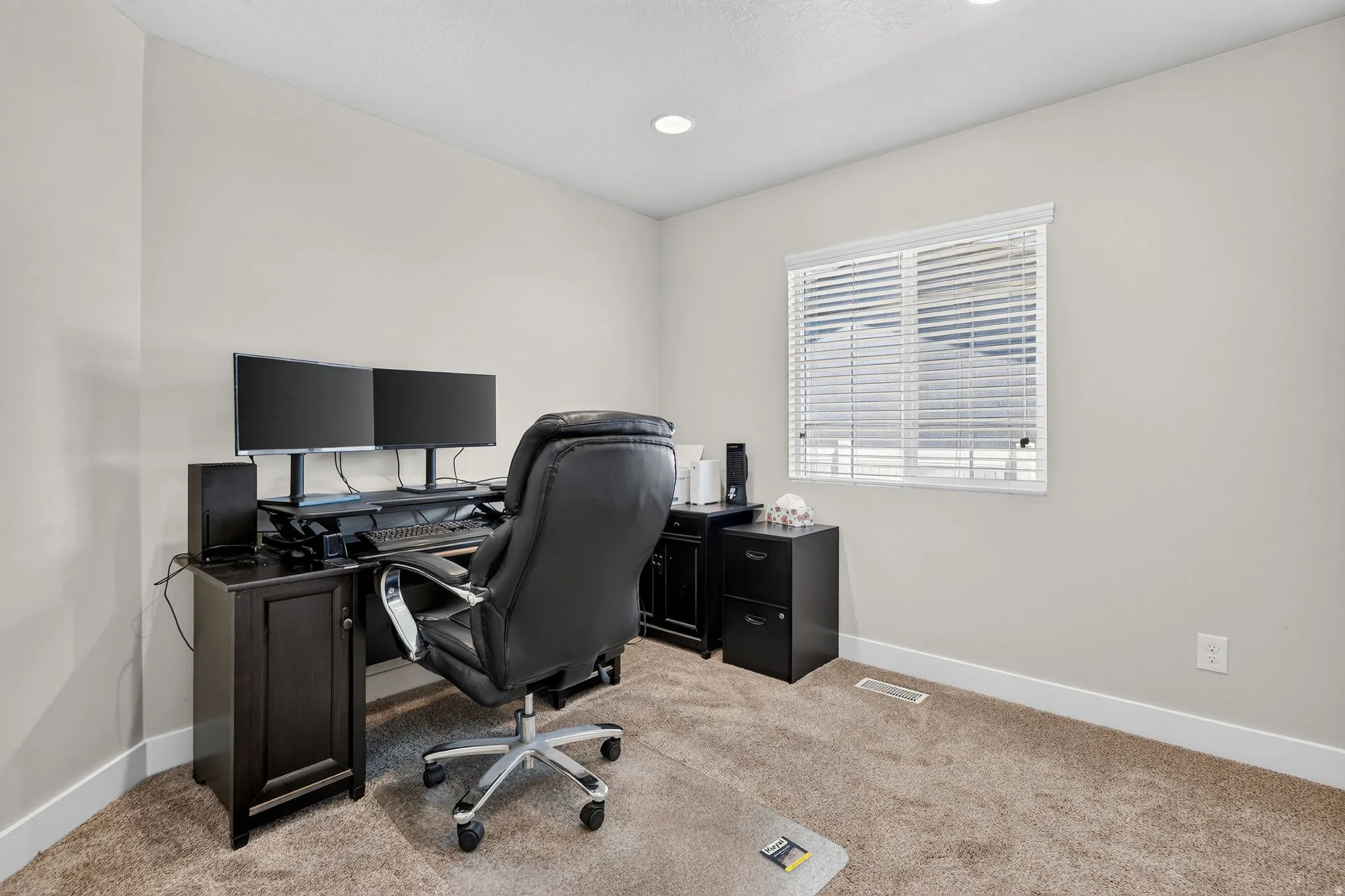 Carpeted room featuring a double-paned window with white blinds, recessed lighting, and light-toned wall finishes