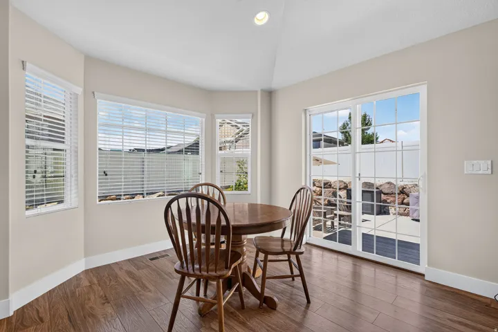 Breakfast nook with wood-finish flooring, ample natural light, recessed ceiling lighting, and patio access via sliding glass doors