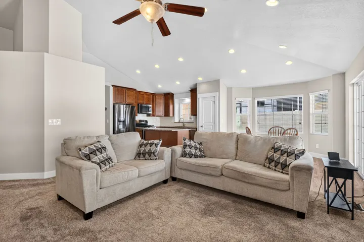 Vaulted ceilings with recessed lighting and a ceiling fan