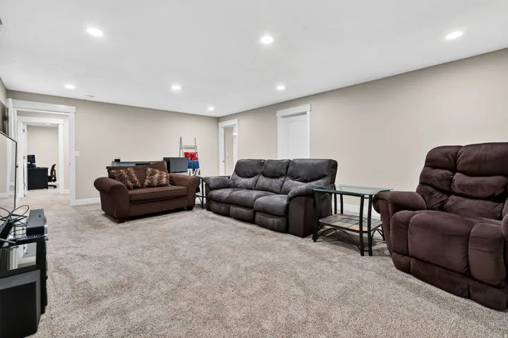 Spacious carpeted room featuring recessed lighting and neutral wall paint