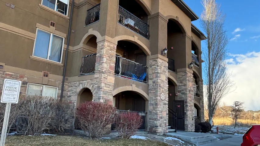 Multi-story stucco exterior featuring stone veneer accents