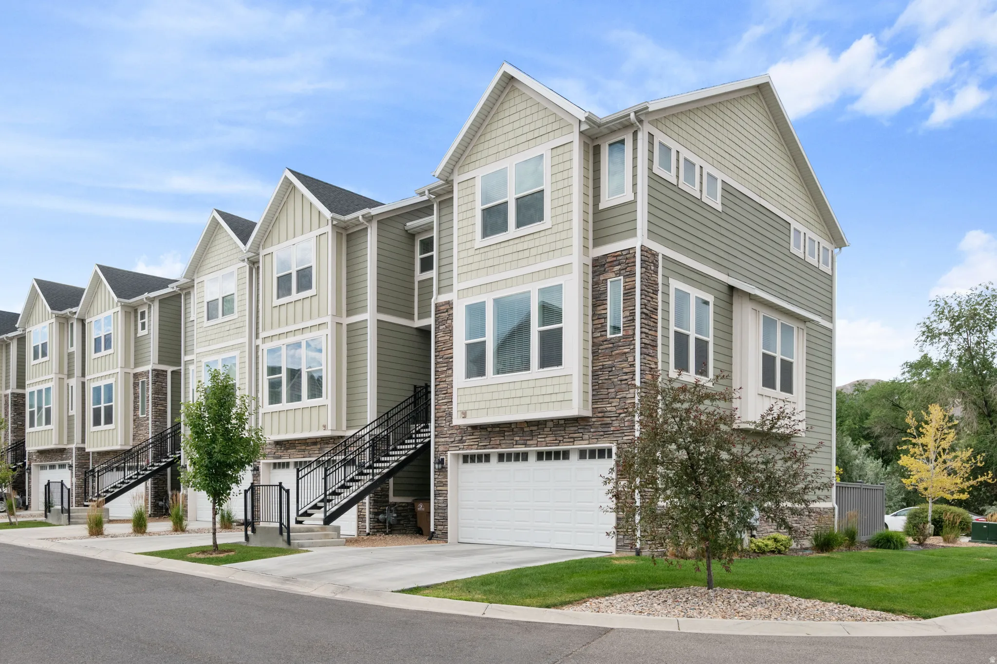 Contemporary multi-story residences featuring horizontal siding and stone veneer accents
