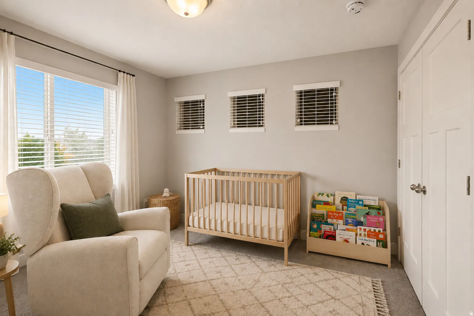 Room featuring a large window with white blinds and drapes, three smaller windows with blinds, a ceiling-mounted light fixture, and a white paneled door