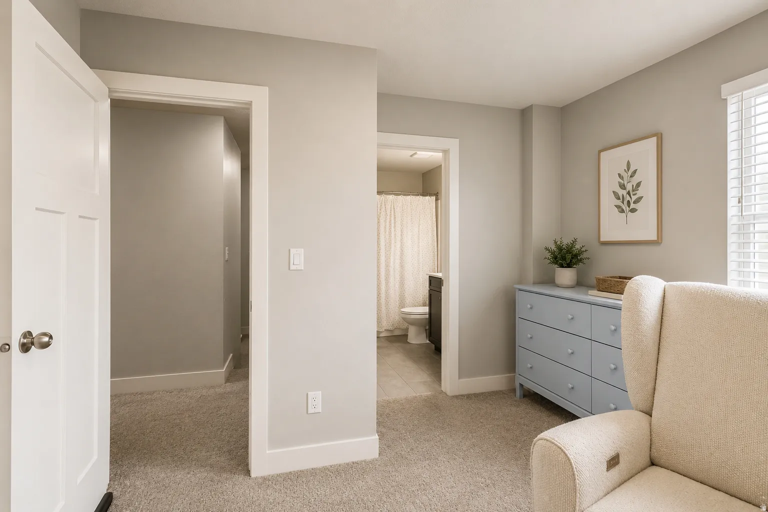 Carpeted room featuring a white door with brushed nickel hardware, light gray walls, white trim, and a window with blinds