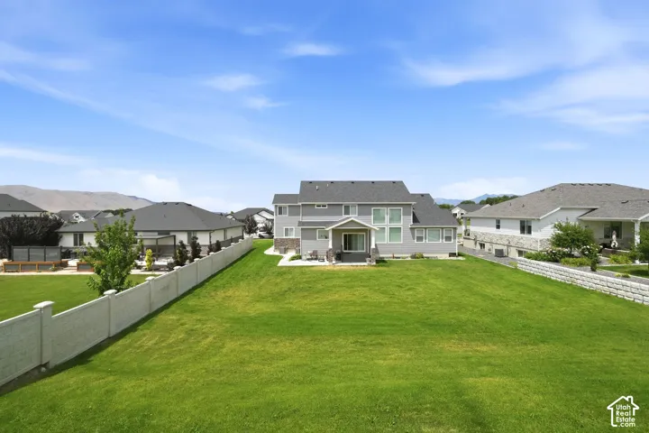 Expansive rear lawn with a full privacy fence