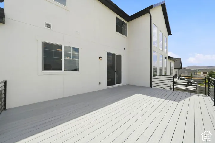Spacious deck featuring composite decking and black metal railings