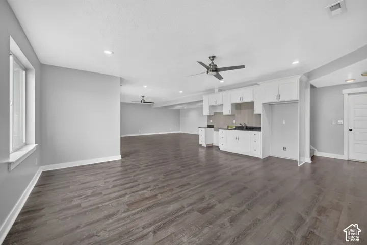 Open-concept area featuring wood-finish flooring, recessed lighting, and a modern ceiling fan