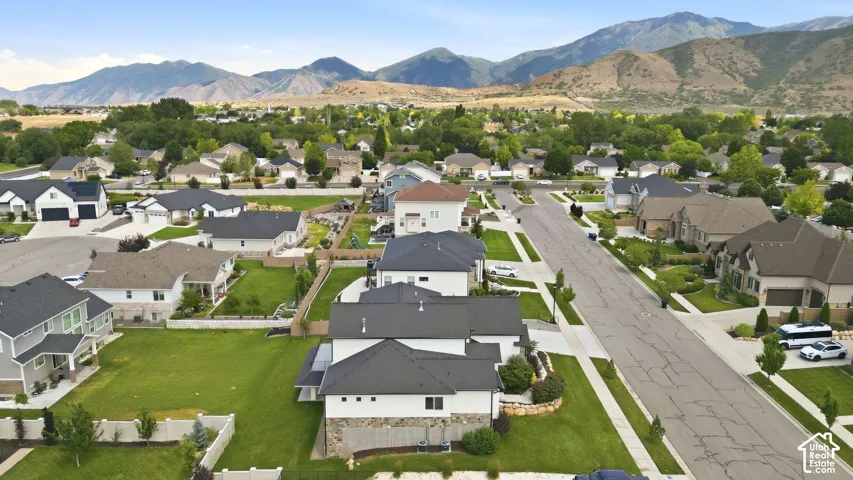 Expansive neighborhood with diverse architectural styles, mature landscaping, and mountain backdrop