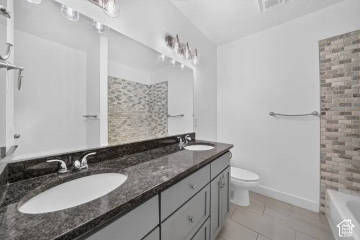 Dual vanity with a dark speckled countertop, undermount sinks, and chrome faucets